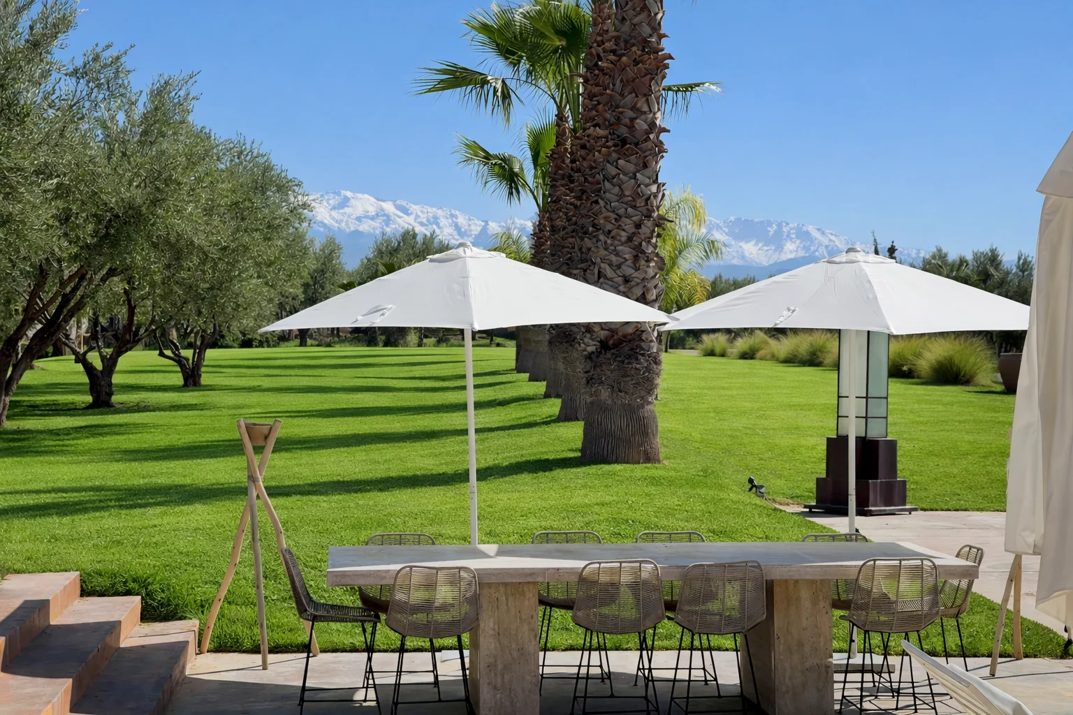 Grande table dressée dans le jardin d’une villa EVG Marrakech pour le dîner du groupe